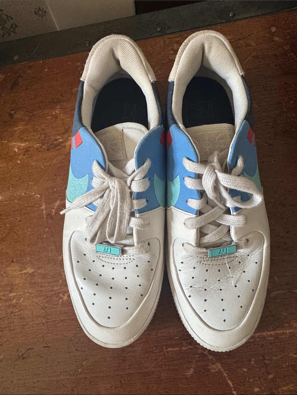 Nike White Sneakers with Teal, Blue & Red Accents
